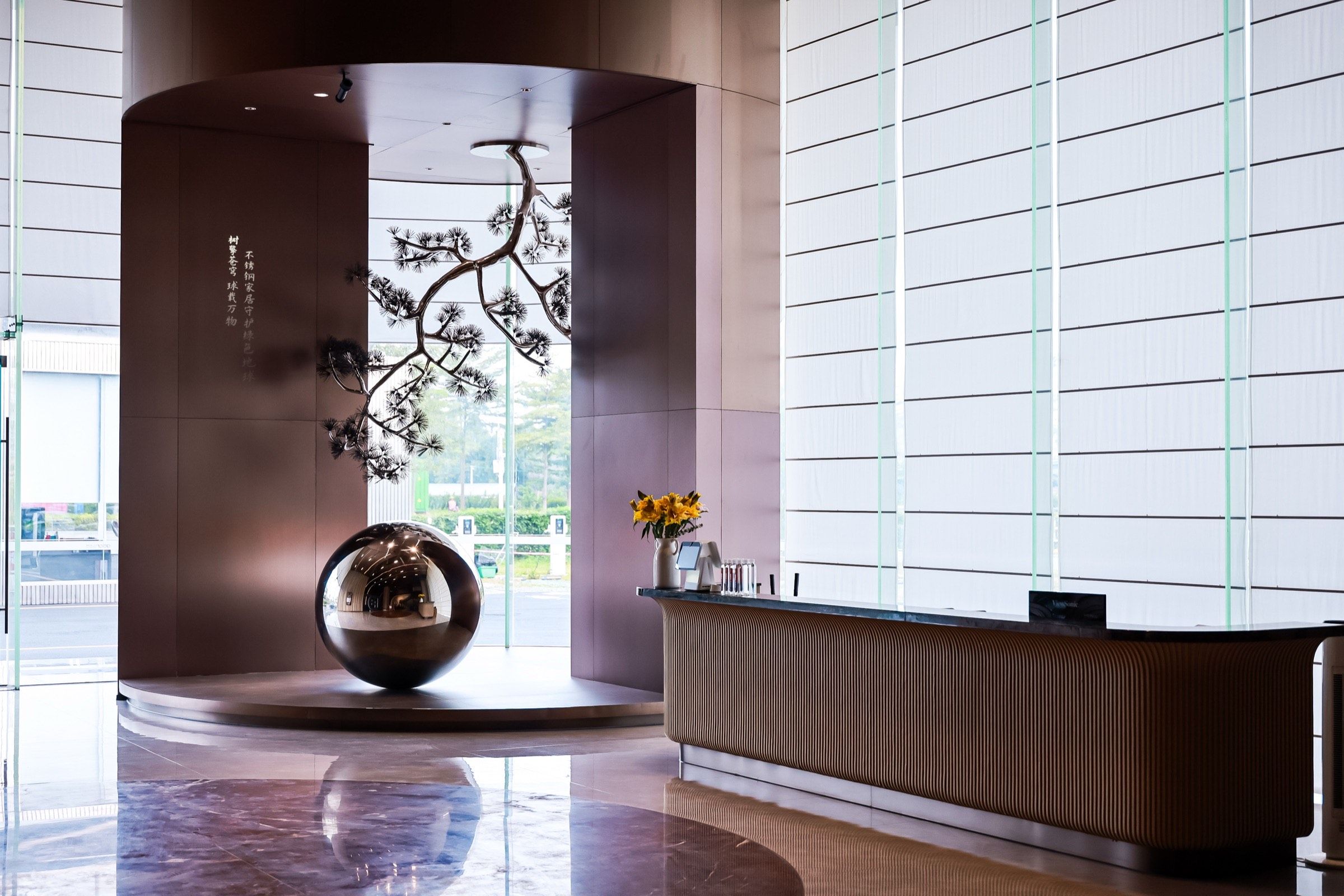 Closing showroom image with sculptural cabinetry and soft light
