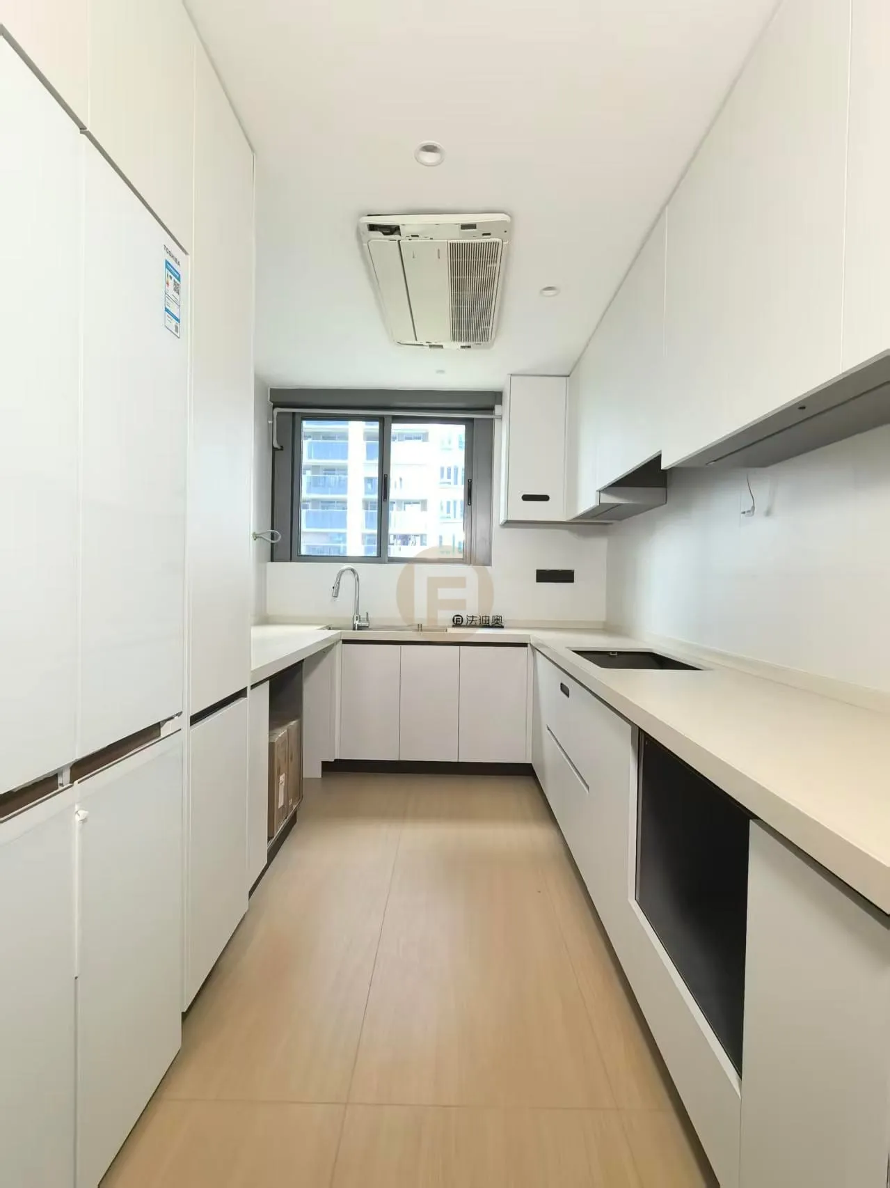 White galley kitchen with stainless steel cabinetry on both sides, dark cooktop and window-end sink run