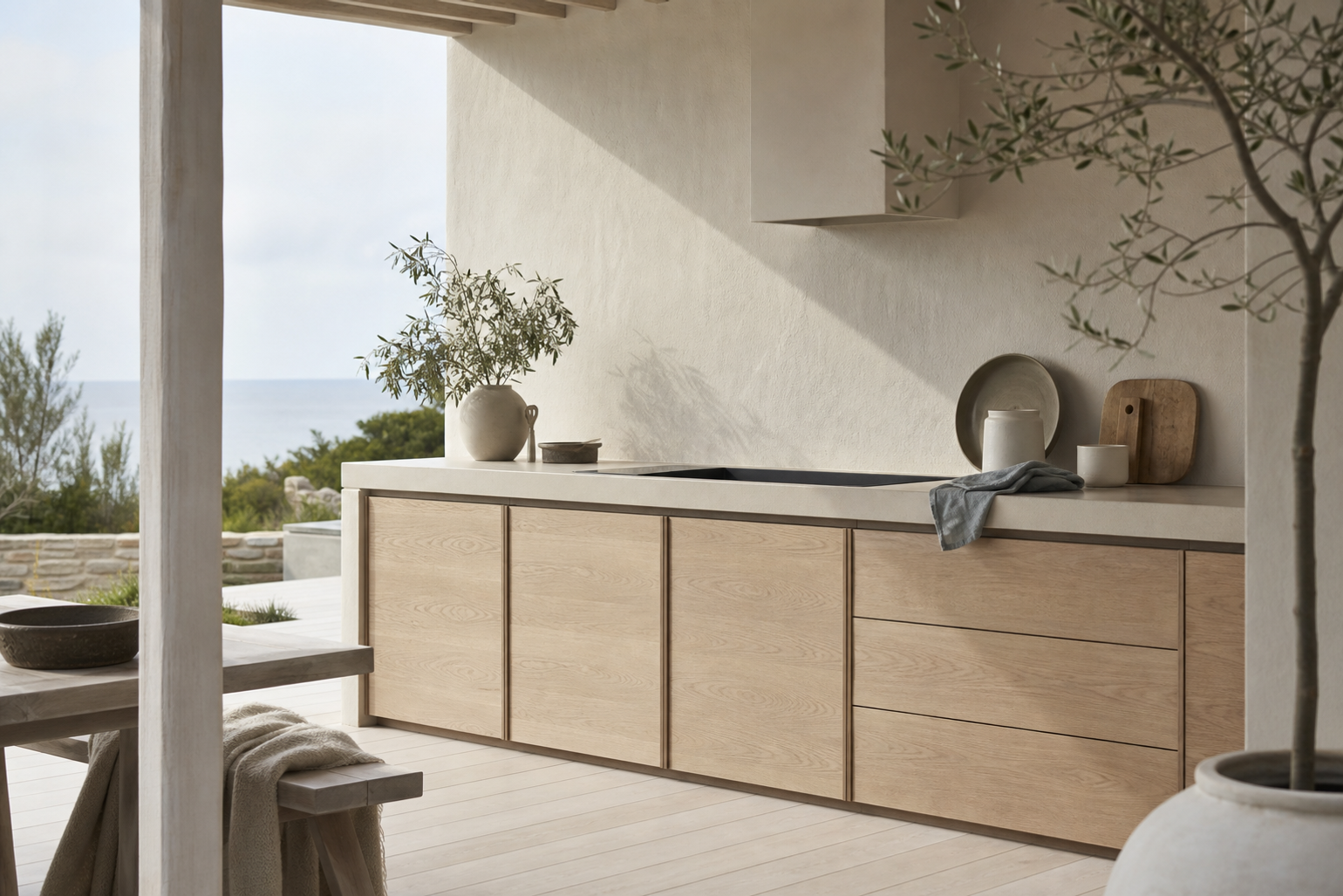 Pale outdoor kitchen surface study with ceramic vessels and soft daylight.