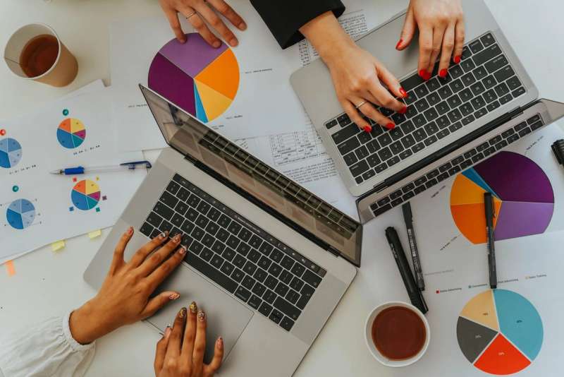 A team analysing a business's local visibility on laptops