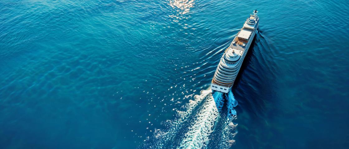 Aerial view of a cruise ship sailing across open ocean water