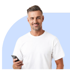 Smiling man in a white t-shirt holding his phone