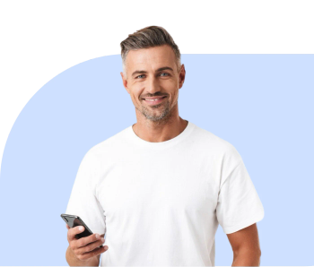 Smiling man in a white t-shirt holding his phone