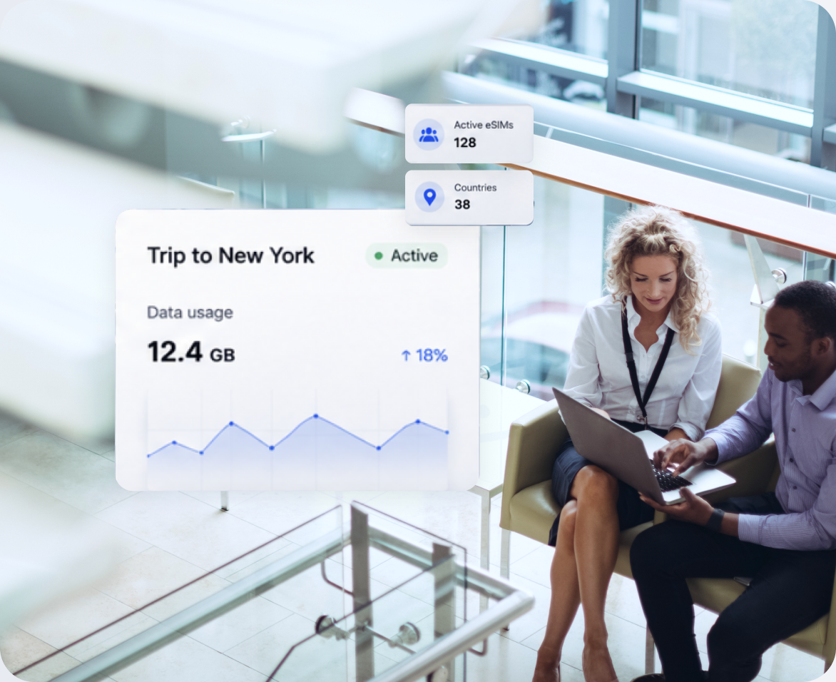 Two colleagues talking in an office beside a data usage chart