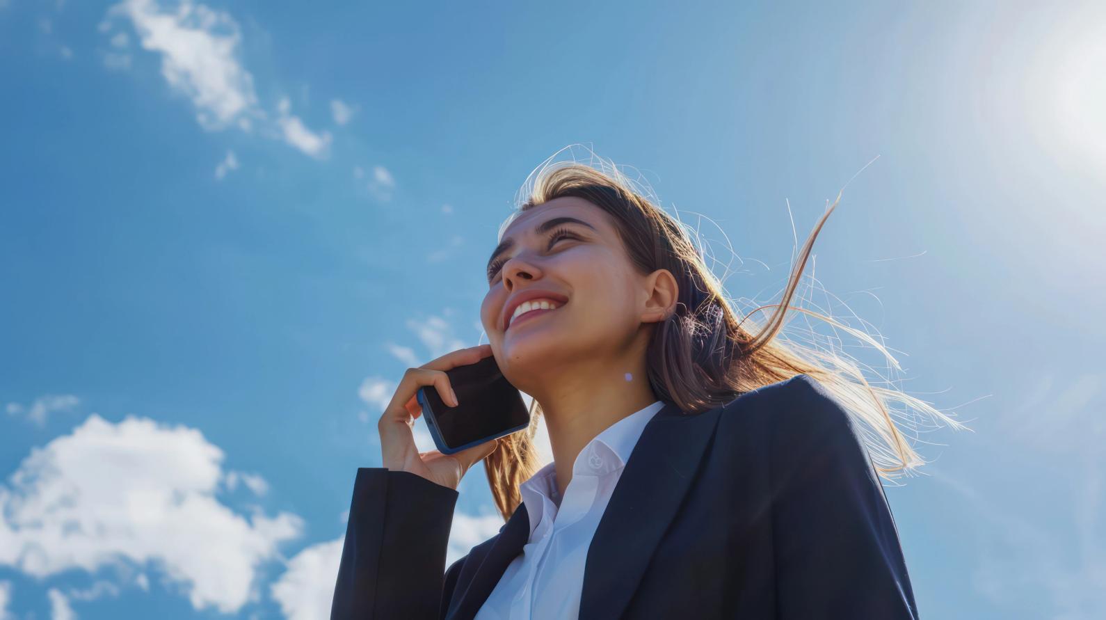 Woman smiling with hair blowing in the wind