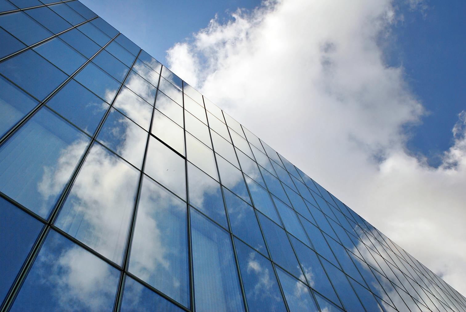 Glass office towers reflecting the sky