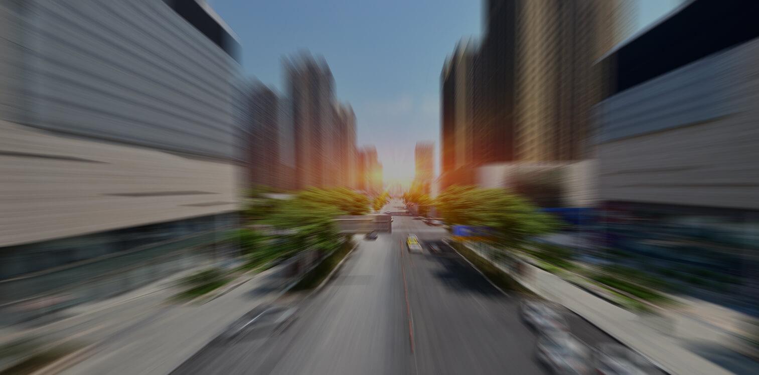 Motion-blurred city street at sunset