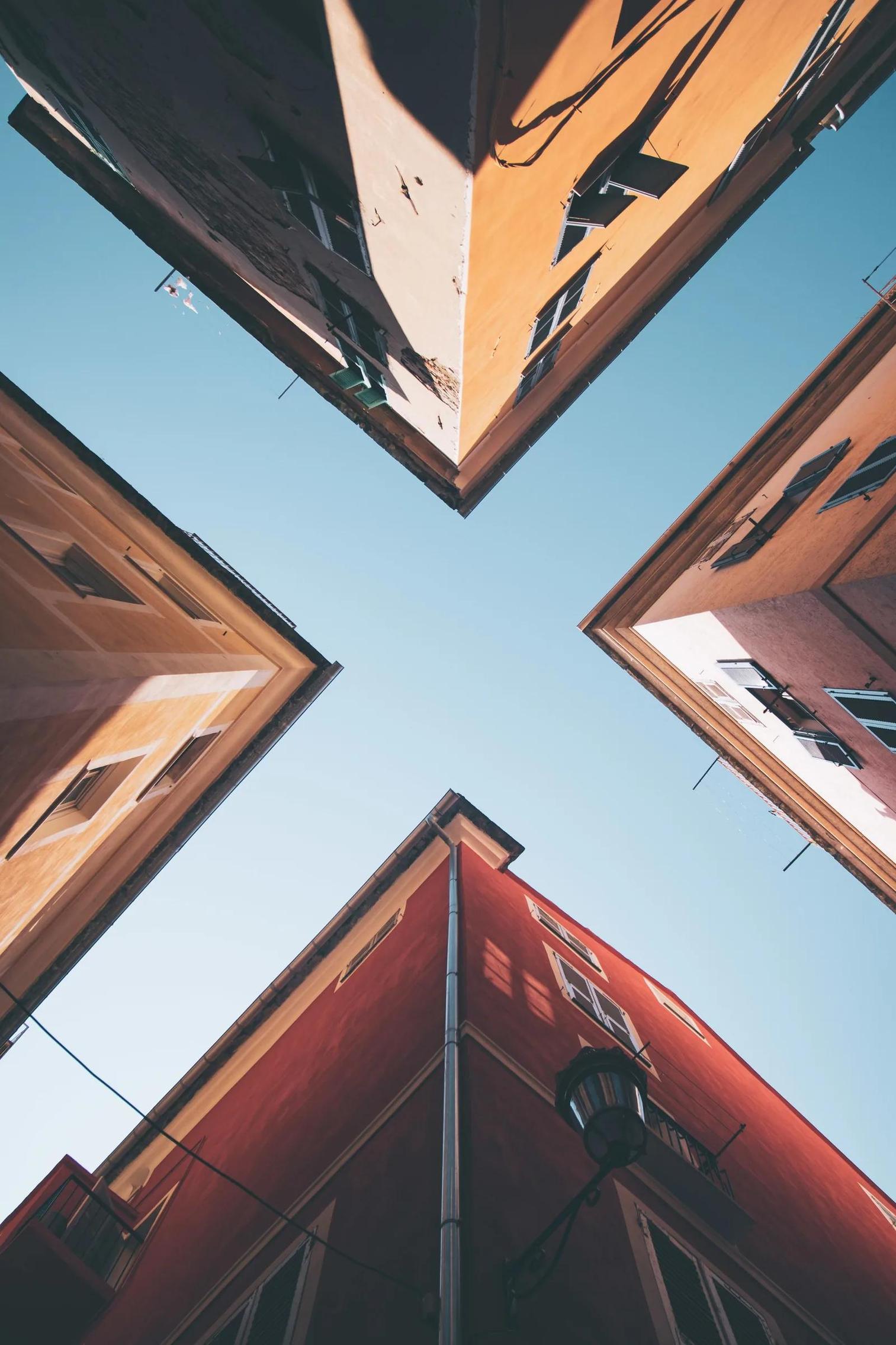 Looking up between buildings at the sky