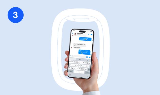 Hand holding a phone with a messaging app open
