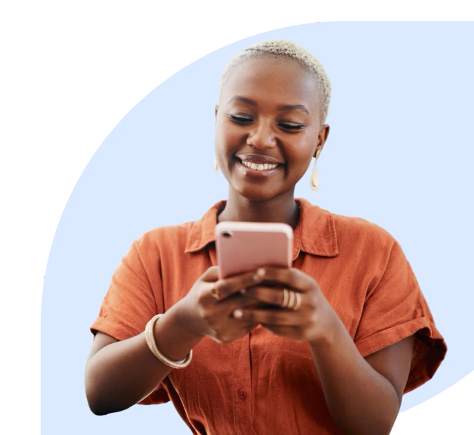Woman working at a desk with a mobile phone