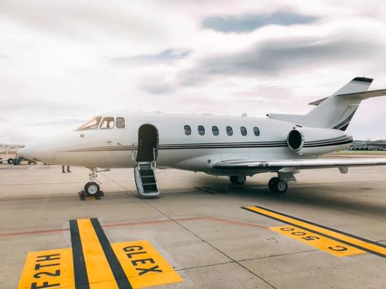 Private jet parked on an airport apron
