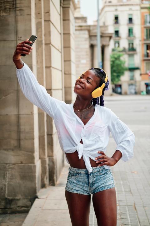 Traveler taking a selfie with headphones on