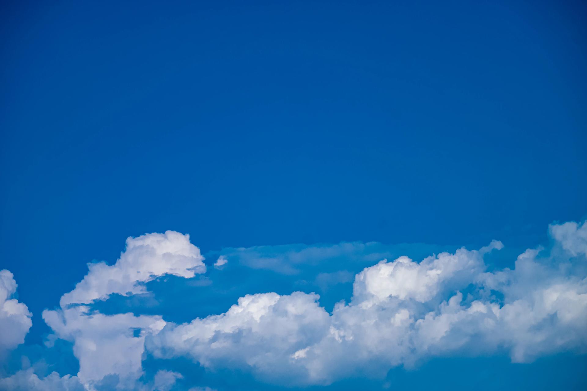 Blue sky with clouds over the horizon