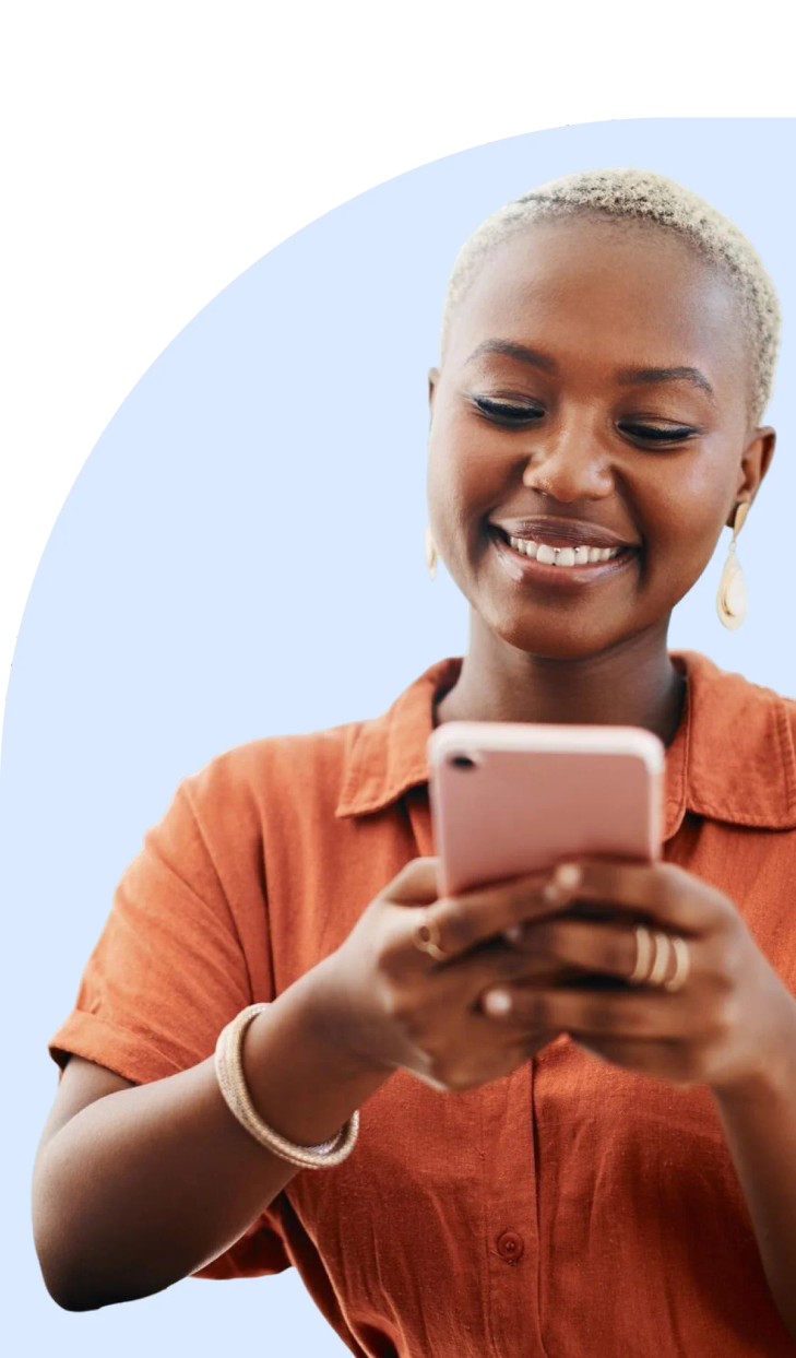 Woman working at a desk with a mobile phone