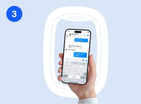 Hand holding a phone with a messaging app open