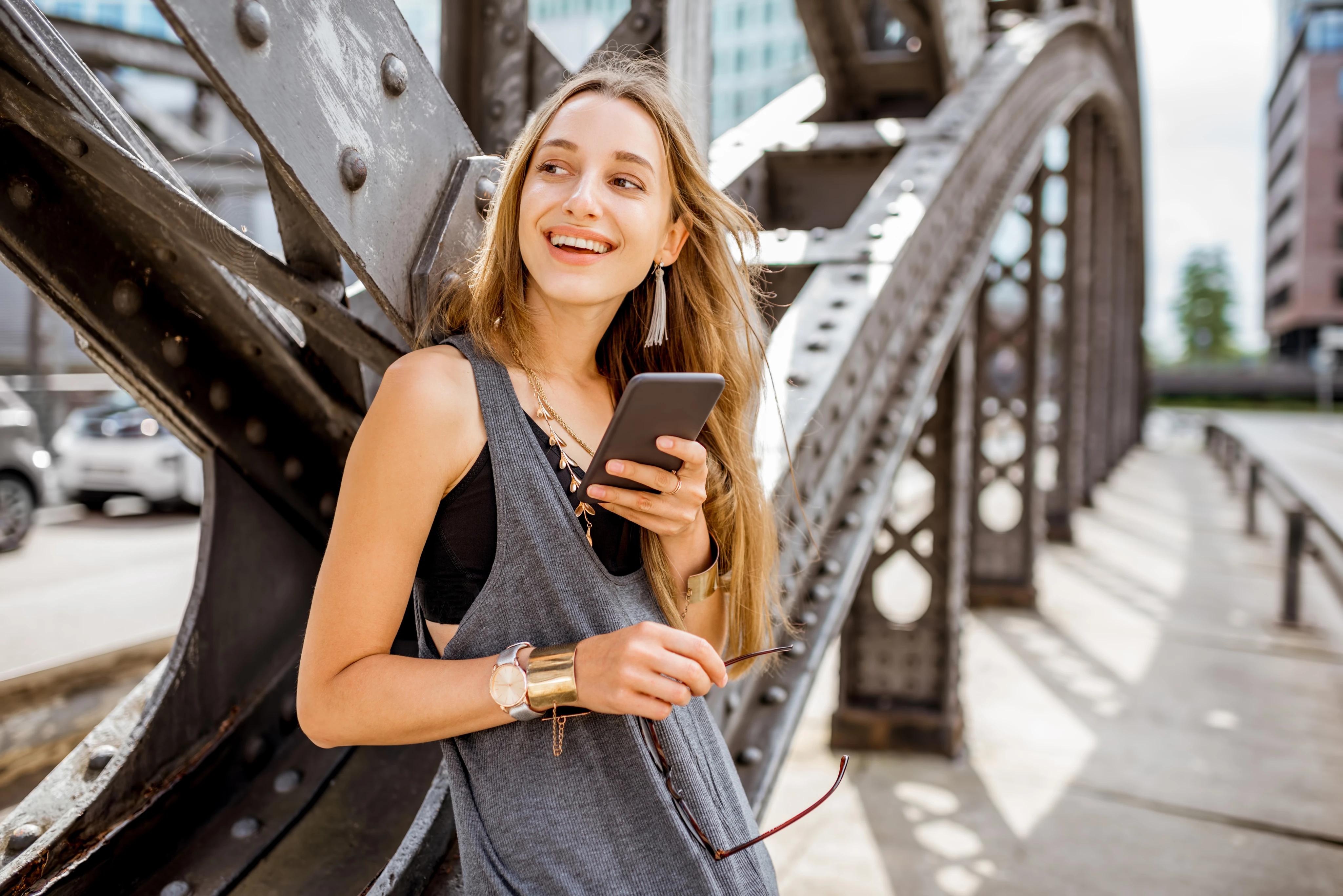 Traveler checking her phone while exploring a city