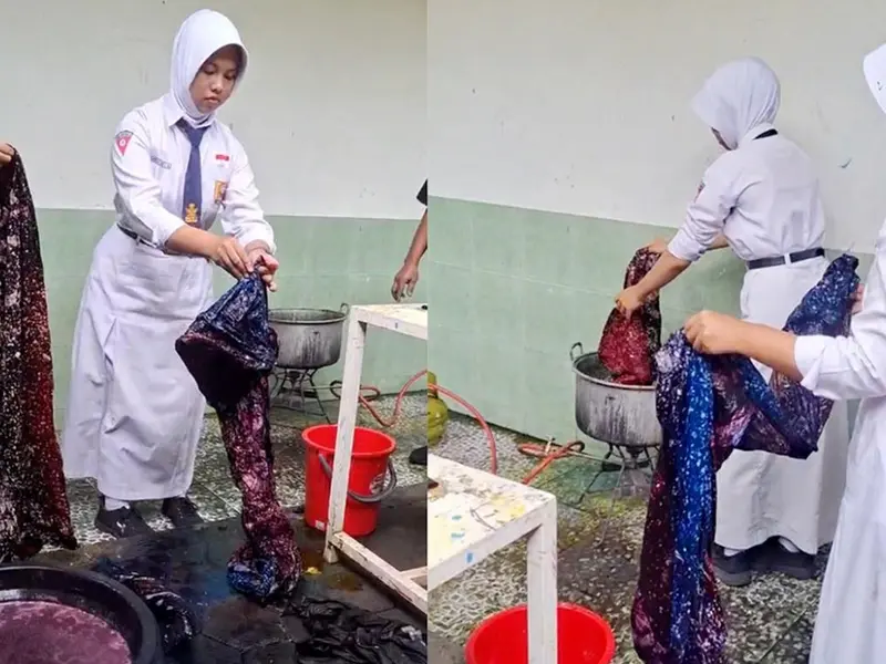 Proses ngelorot untuk menghilangkan malam dari kain batik menggunakan air panas.