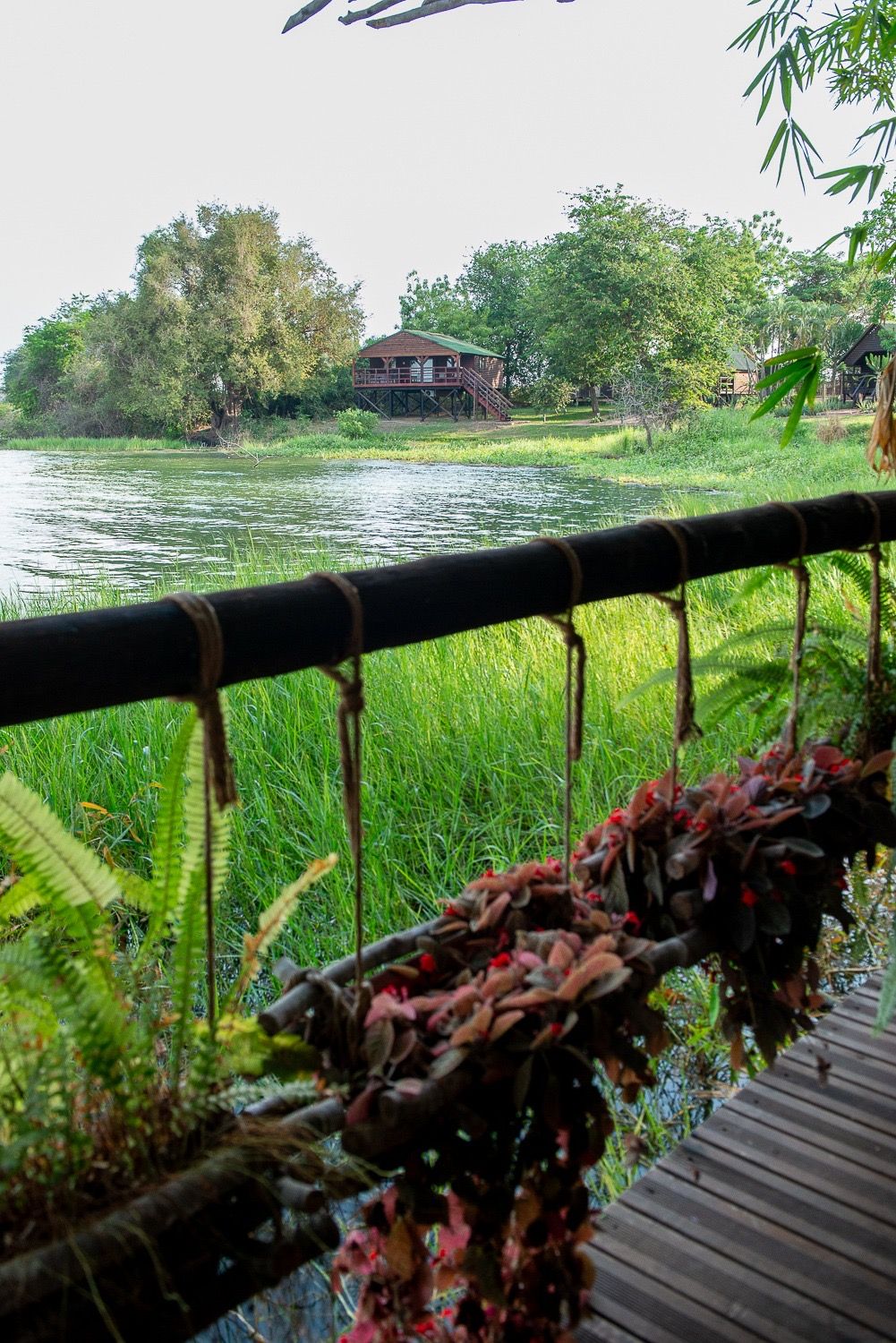 View of the lagoon from a cabana balcony, another cabana on the far shore