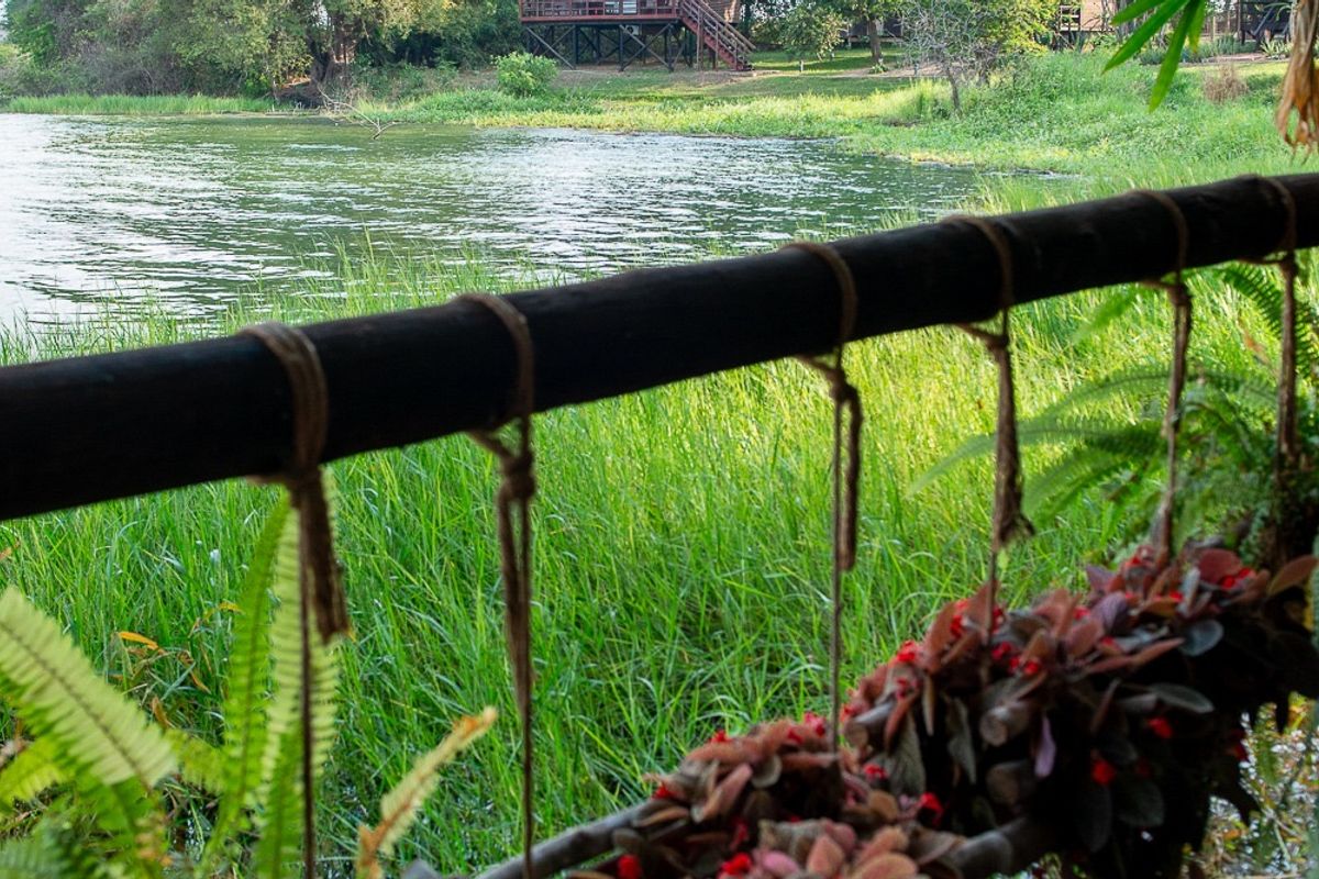 View of the lagoon from a cabana balcony, another cabana on the far shore
