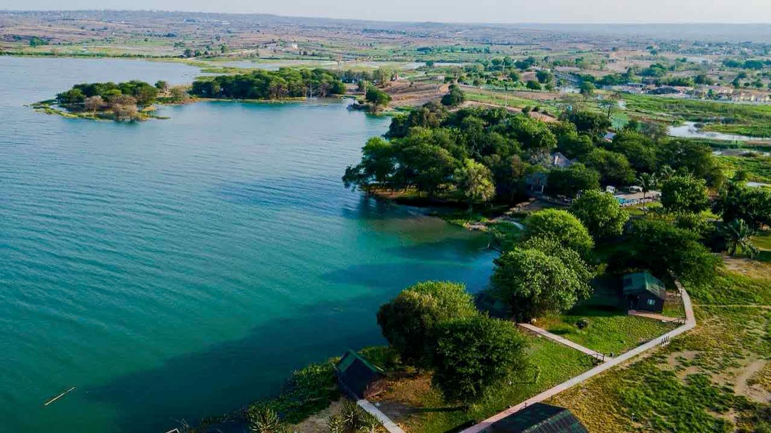 Aerial view of Mubanga Lodge on a green peninsula in the Kilunda Lagoon