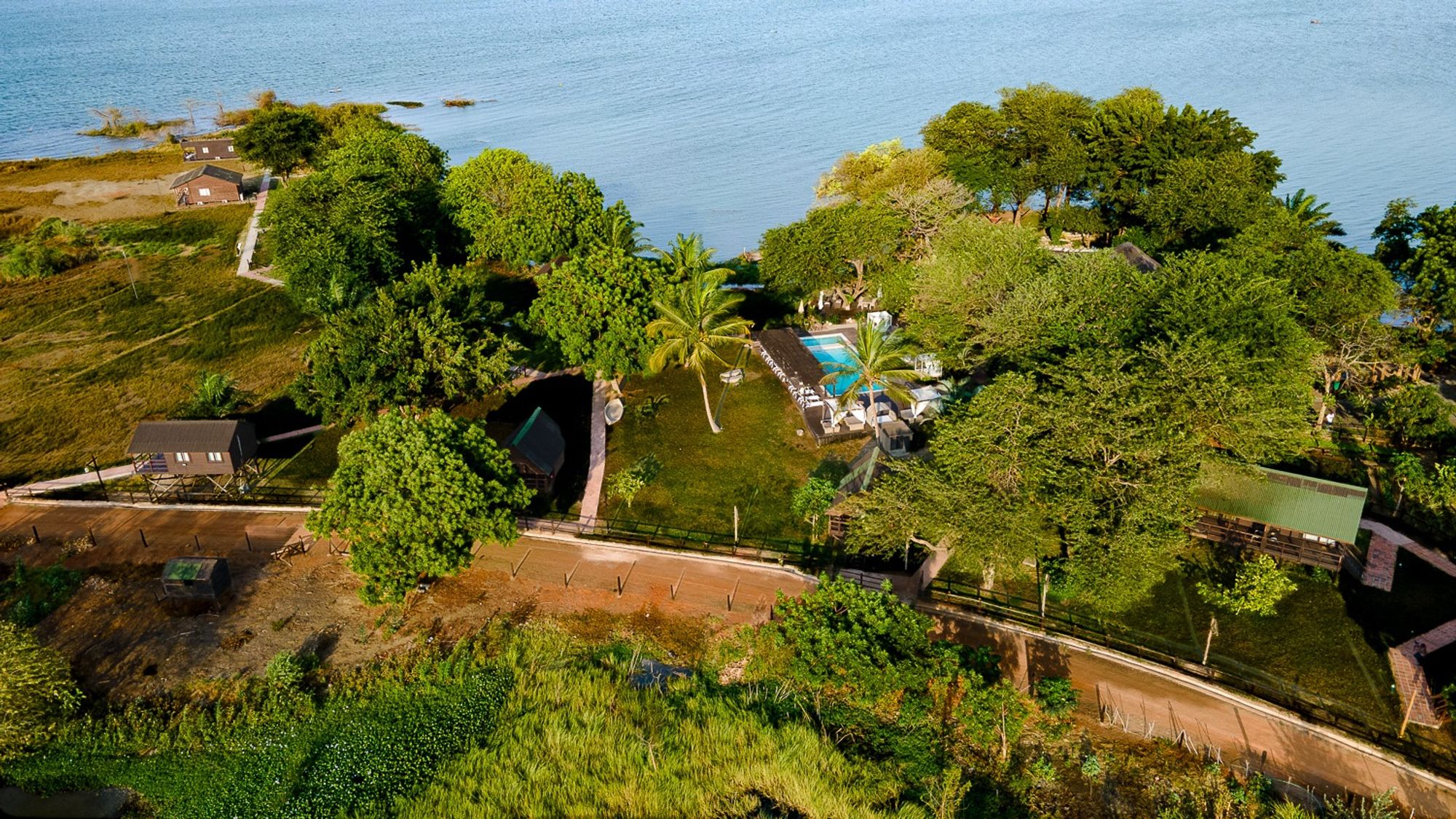 Aerial view of the pool, gardens and cabanas beside the lagoon