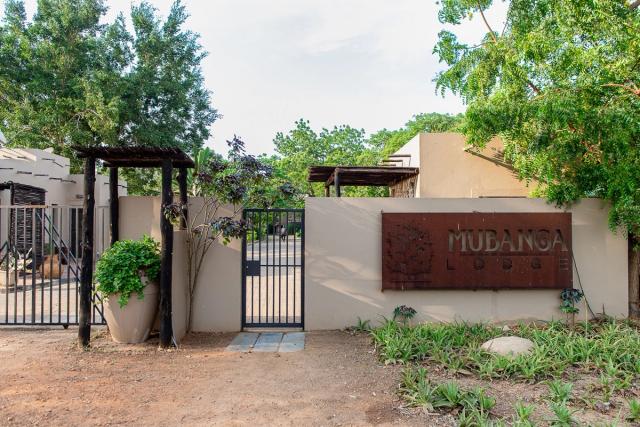 Mubanga Lodge entrance gate with the lodge's name on a rusted metal sign