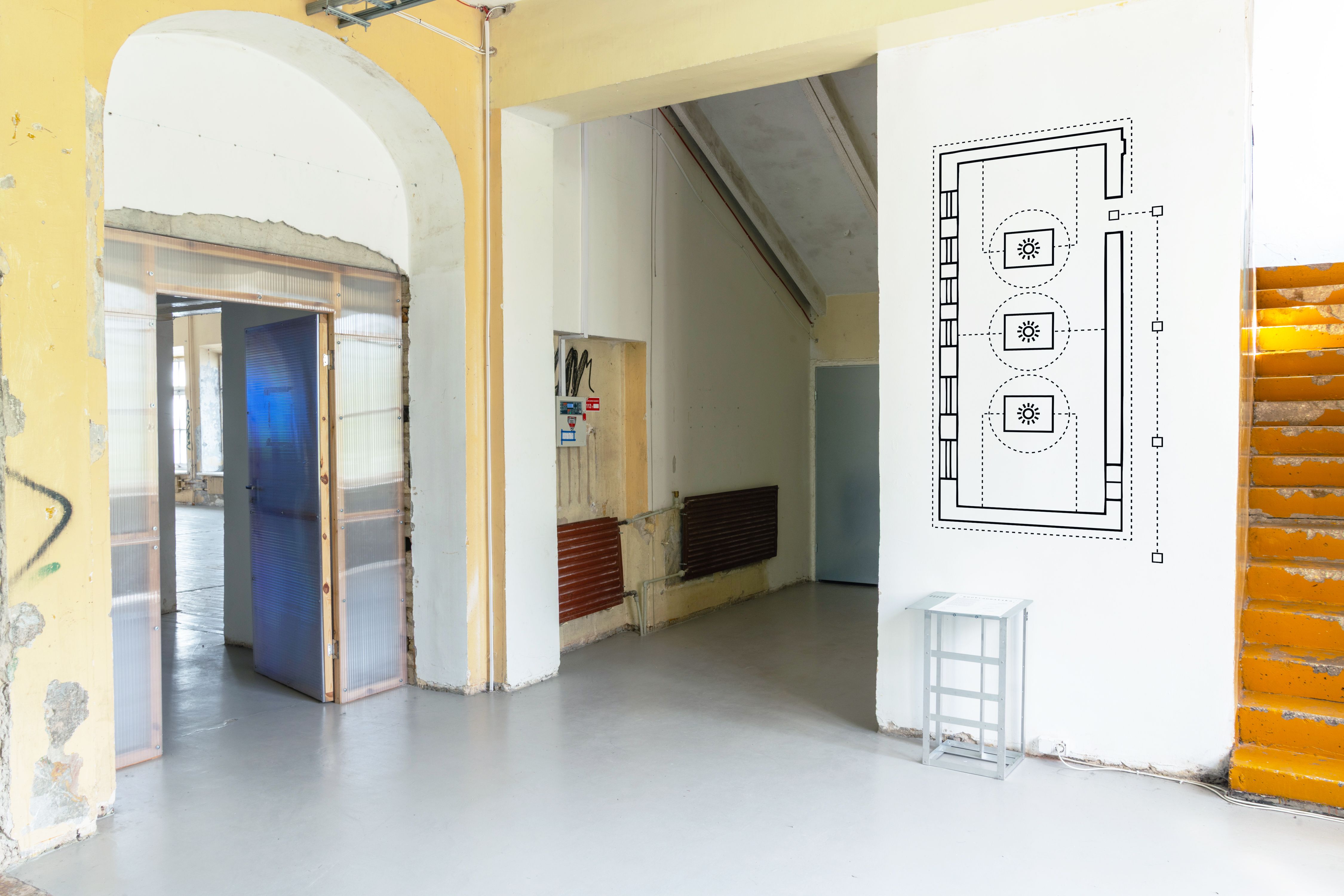 Gallery entrance with a line-drawn wall diagram, Geotraumatika