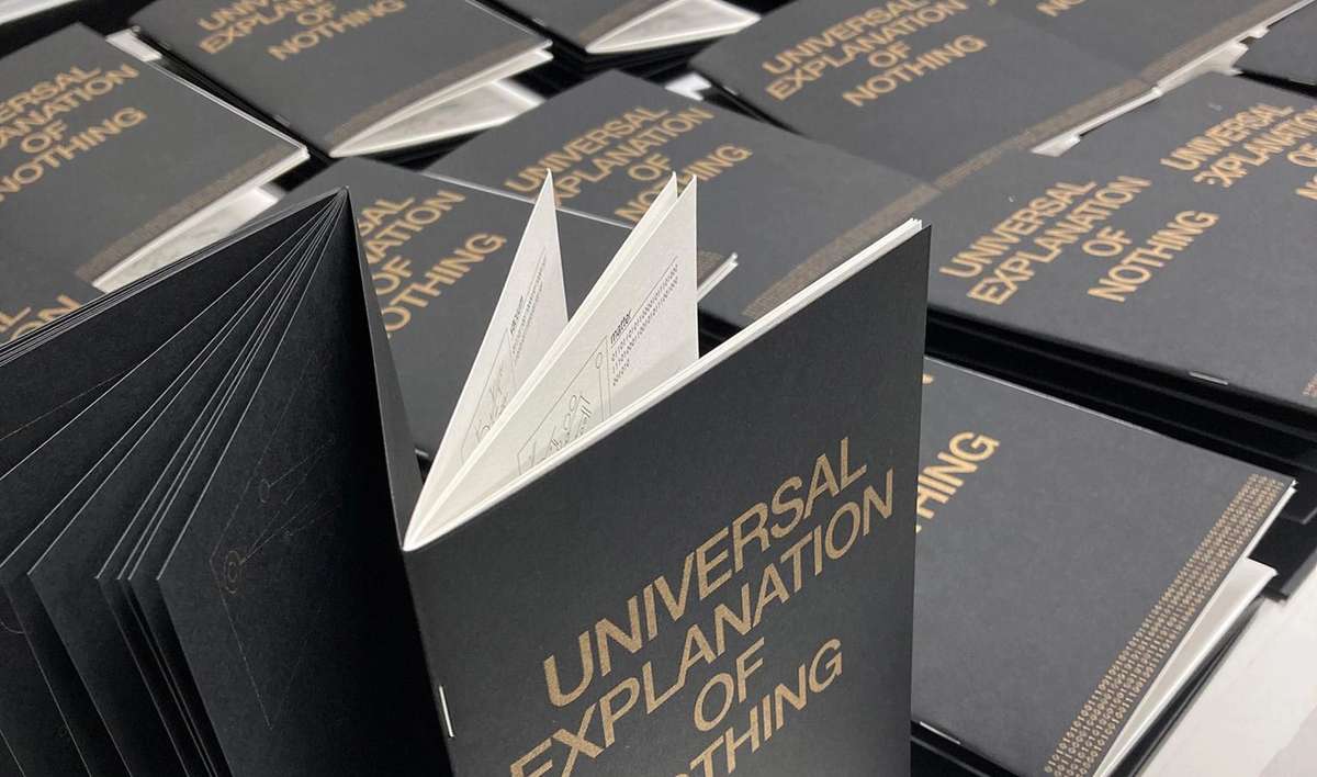 Stacks of Universal Explanation of Nothing books, one standing open
