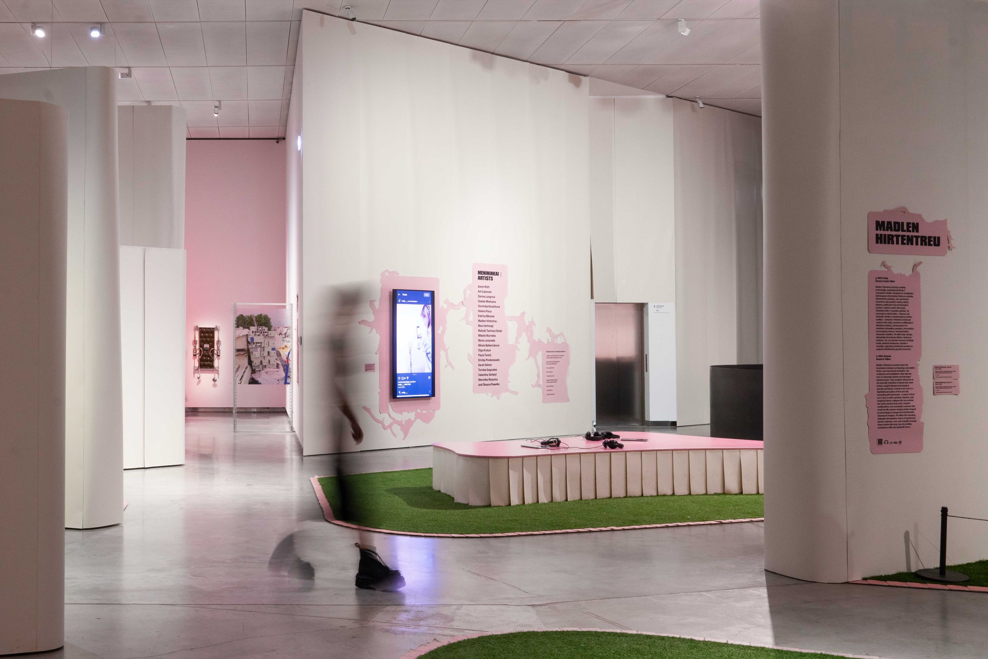 Gen Z. All at Once exhibition hall with pink wall texts and artificial grass, MO Museum