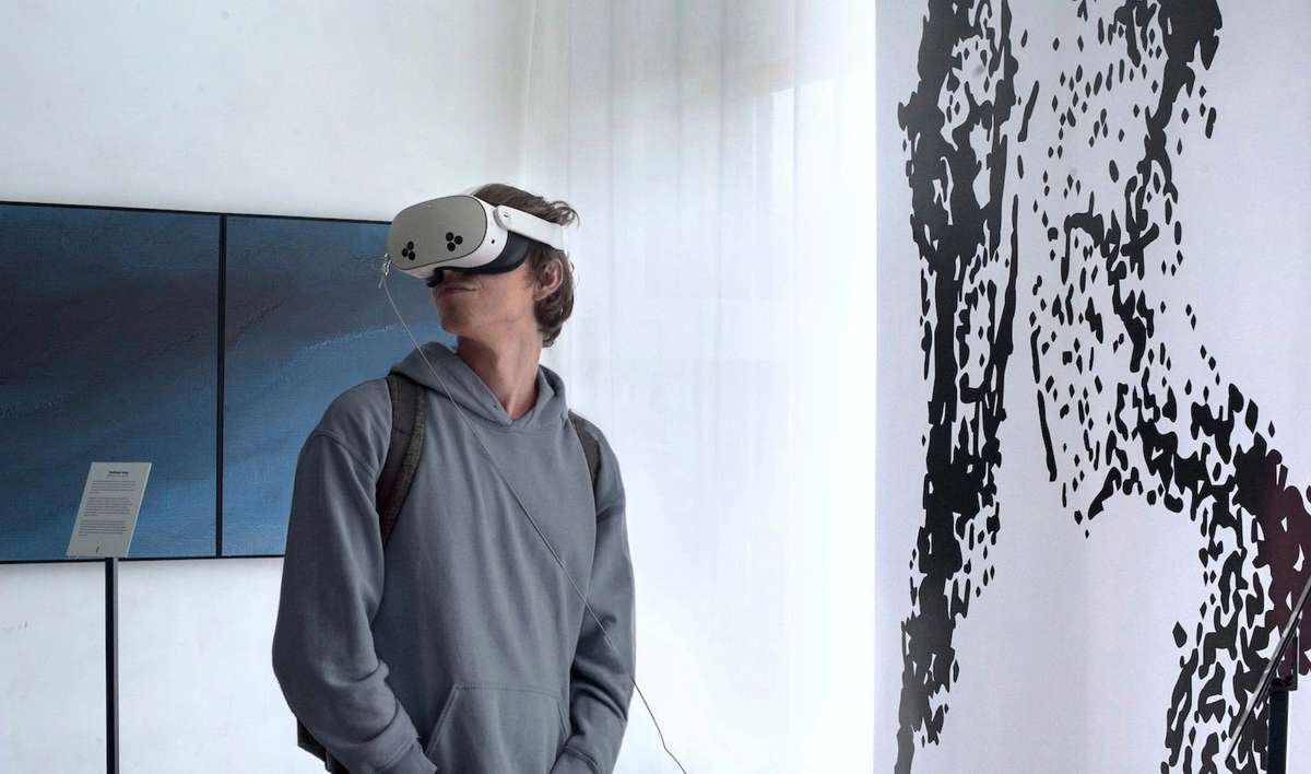 Visitor wearing a VR headset in the Invisible Fungi installation