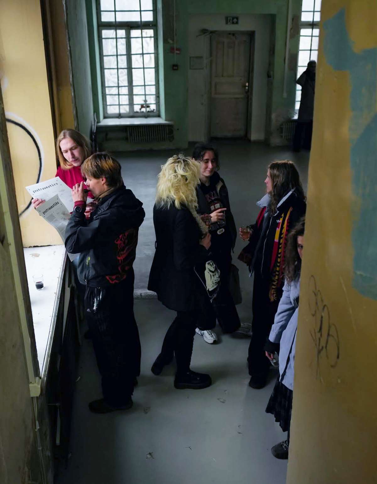 Visitors in a raw gallery corridor at the Geotraumatika opening