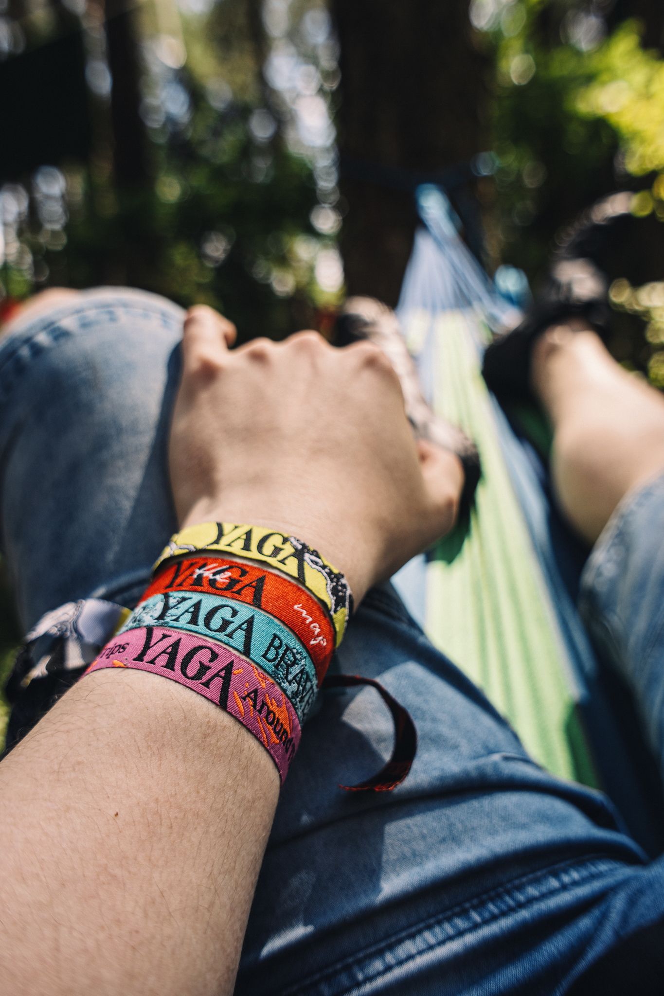 A wrist with colourful YAGA festival wristbands