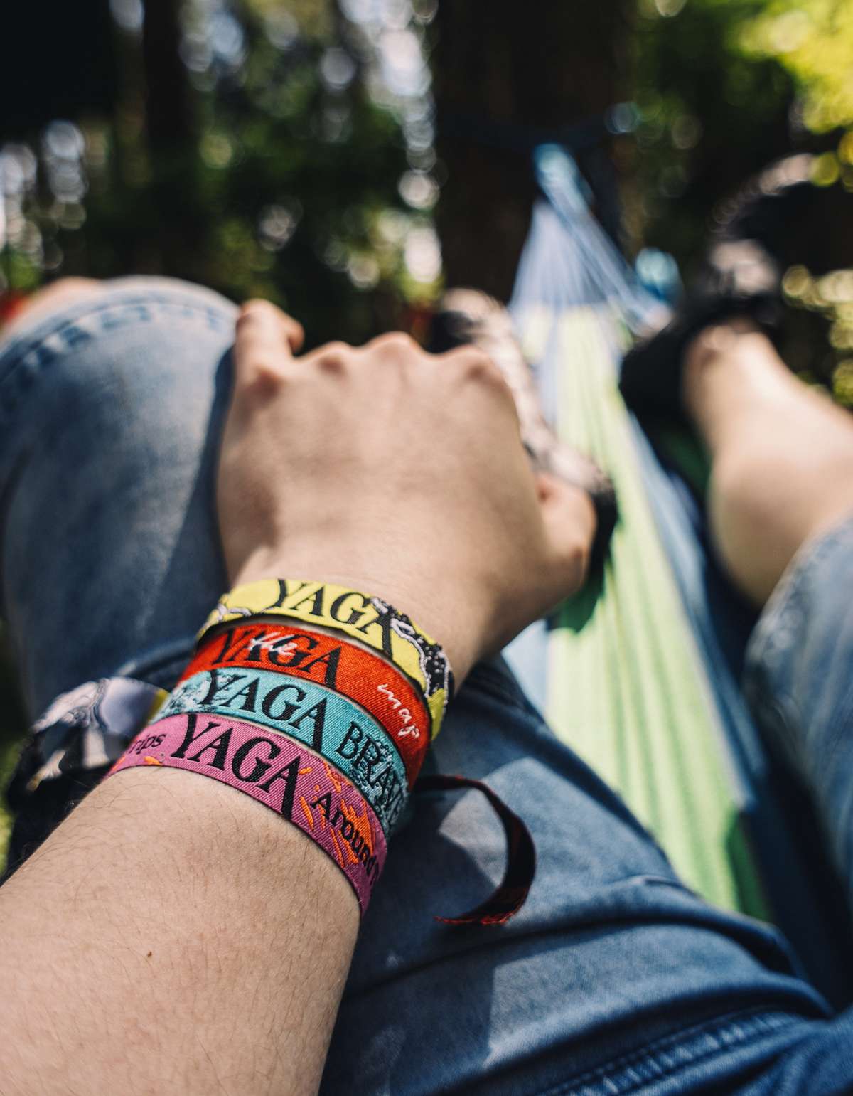 A wrist with colourful YAGA festival wristbands