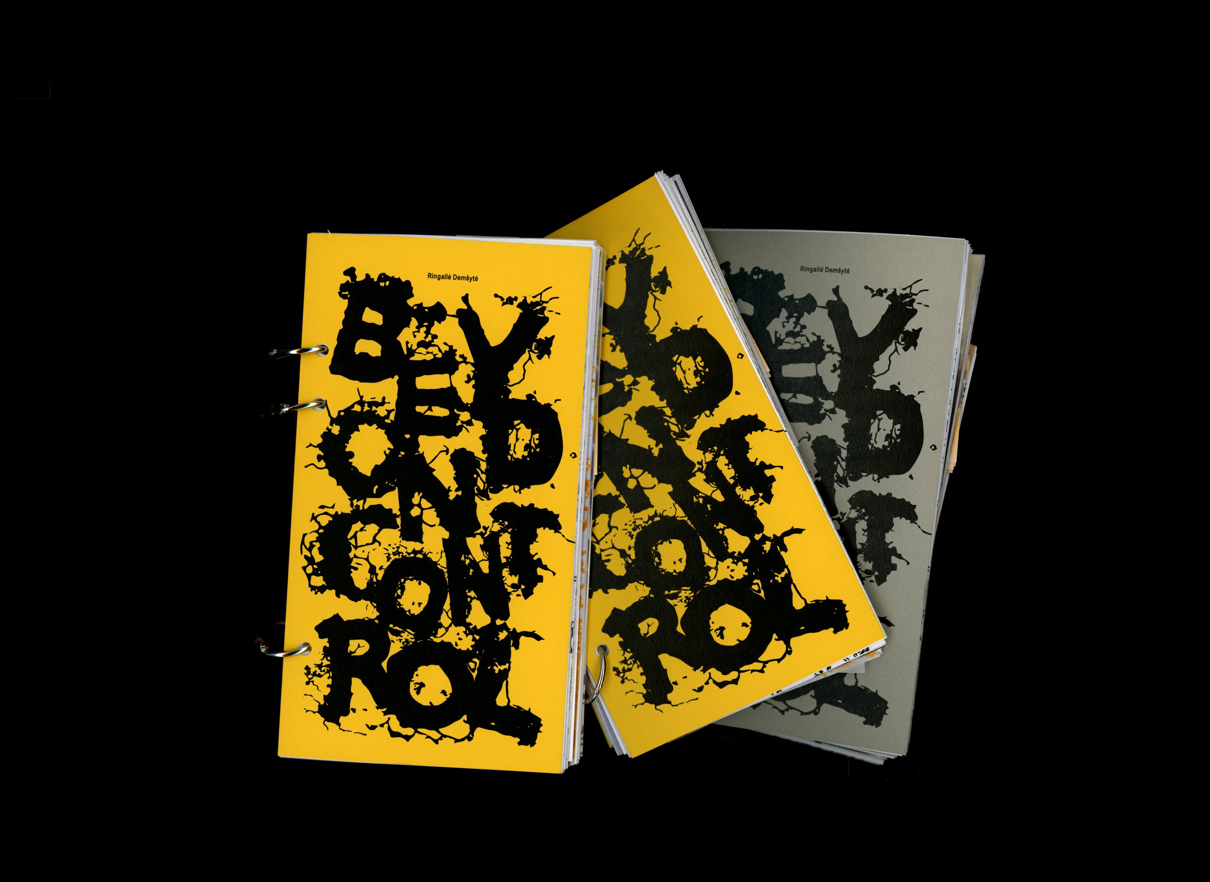 Two copies of the Beyond Control book, with black slime-mould lettering on yellow and grey covers