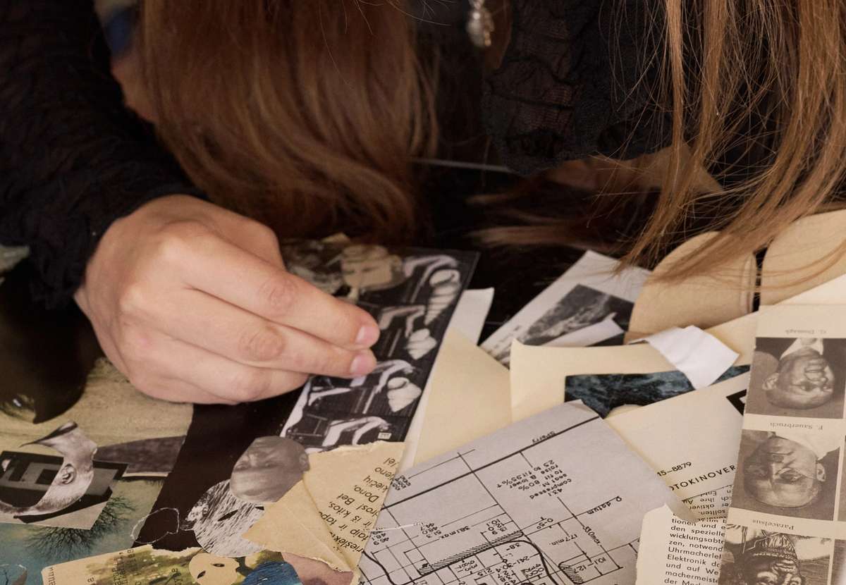 A participant cutting and pasting her zine spread