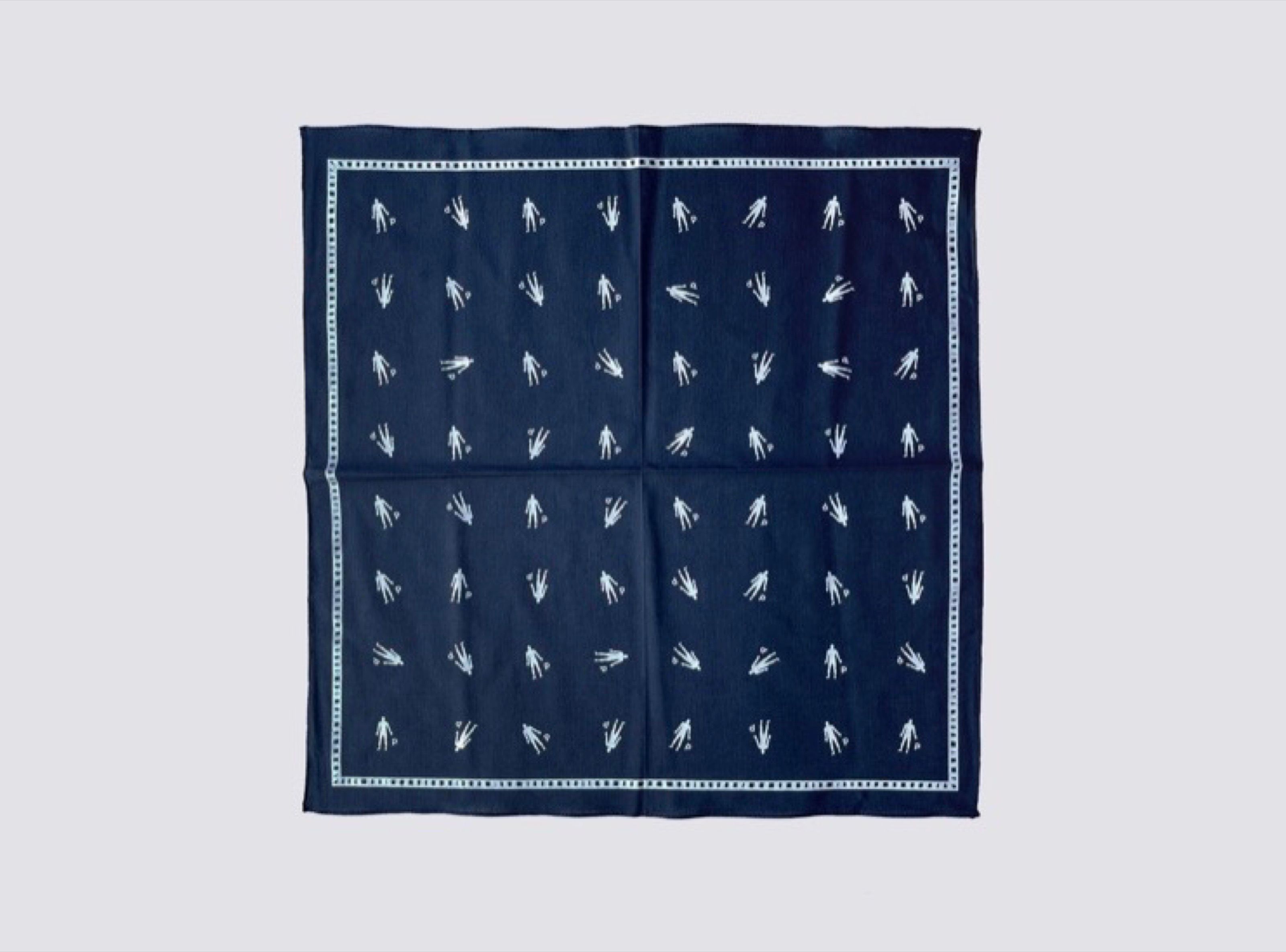 Navy bandana laid flat with a repeated white figure pattern