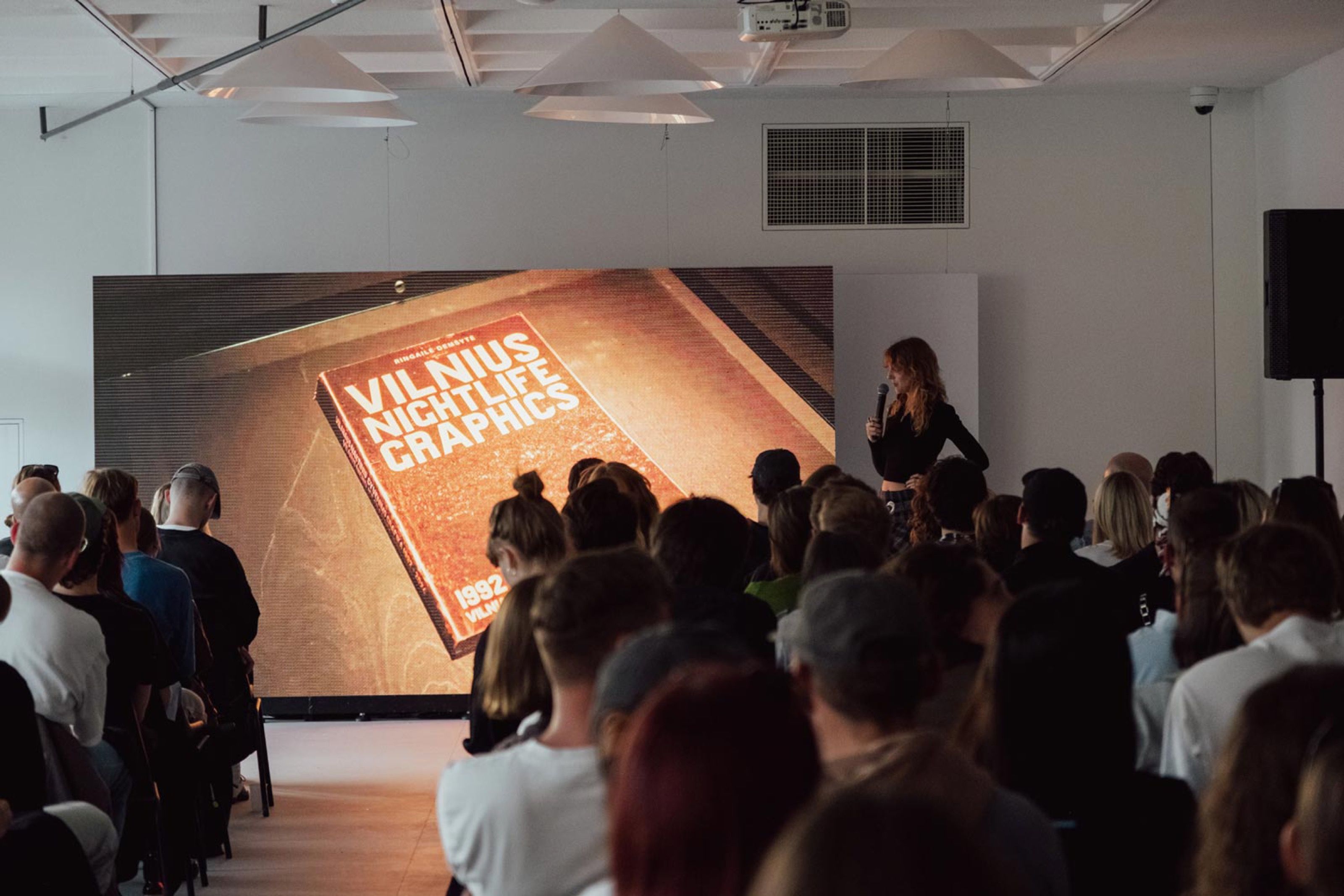 Audience watching a presentation of the Vilnius Nightlife Graphics book