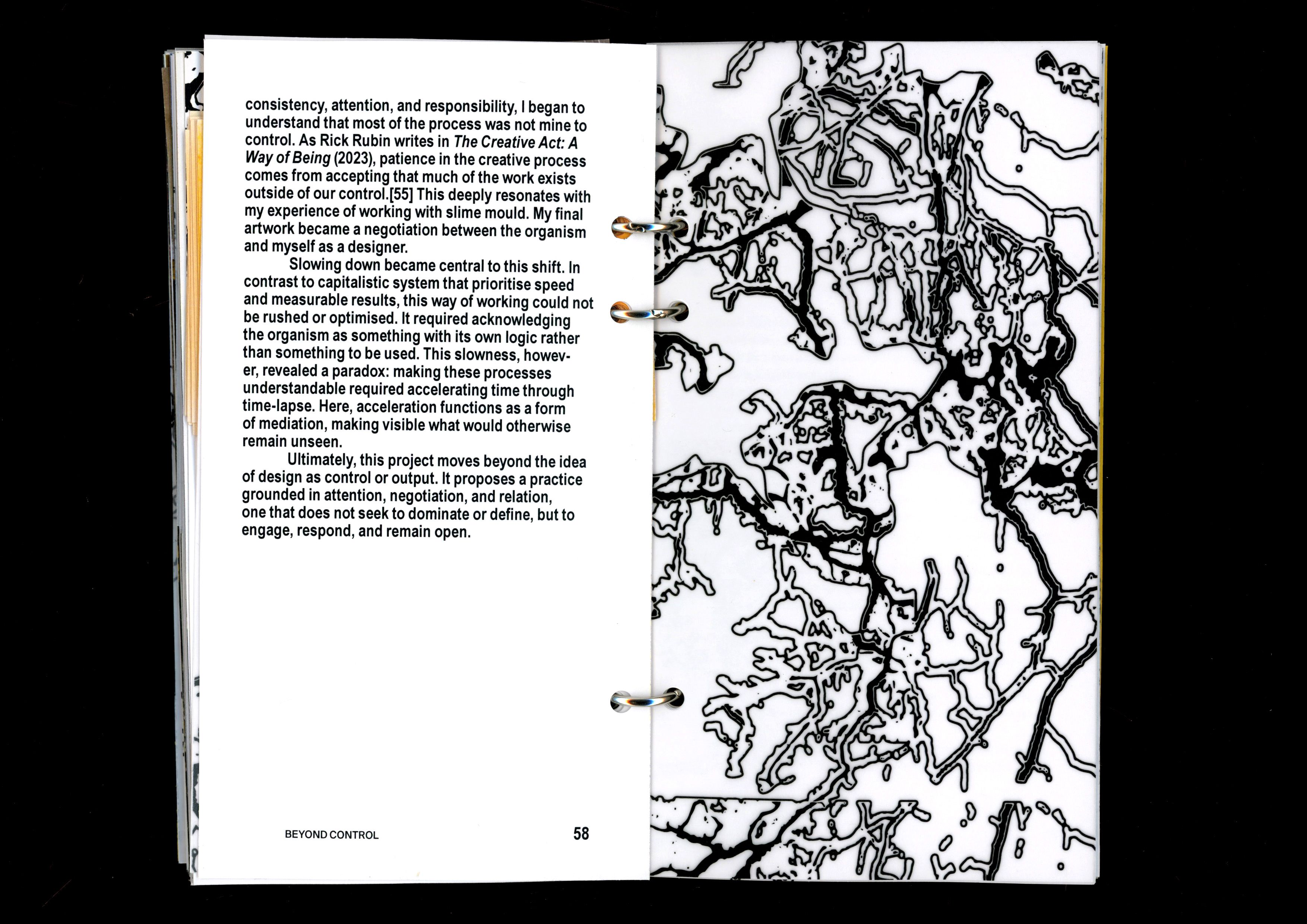 Book spread with text beside a large black slime-mould network drawing