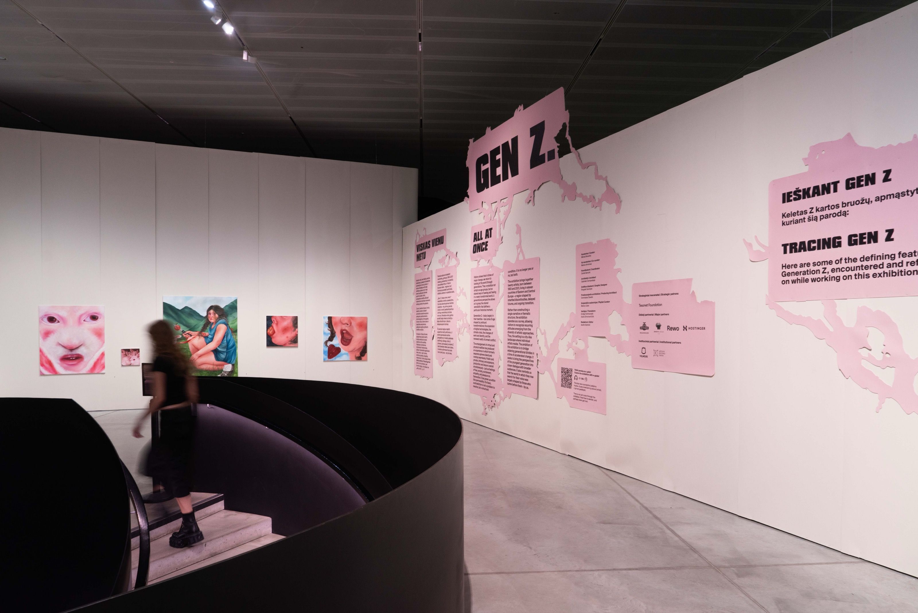 Gen Z. All at Once exhibition wall with pink graphics and artworks