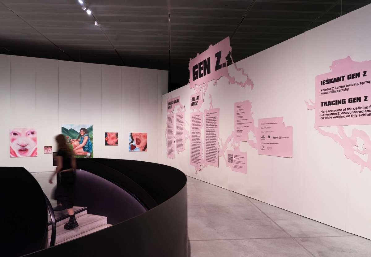 Gen Z. All at Once exhibition wall with pink graphics and artworks