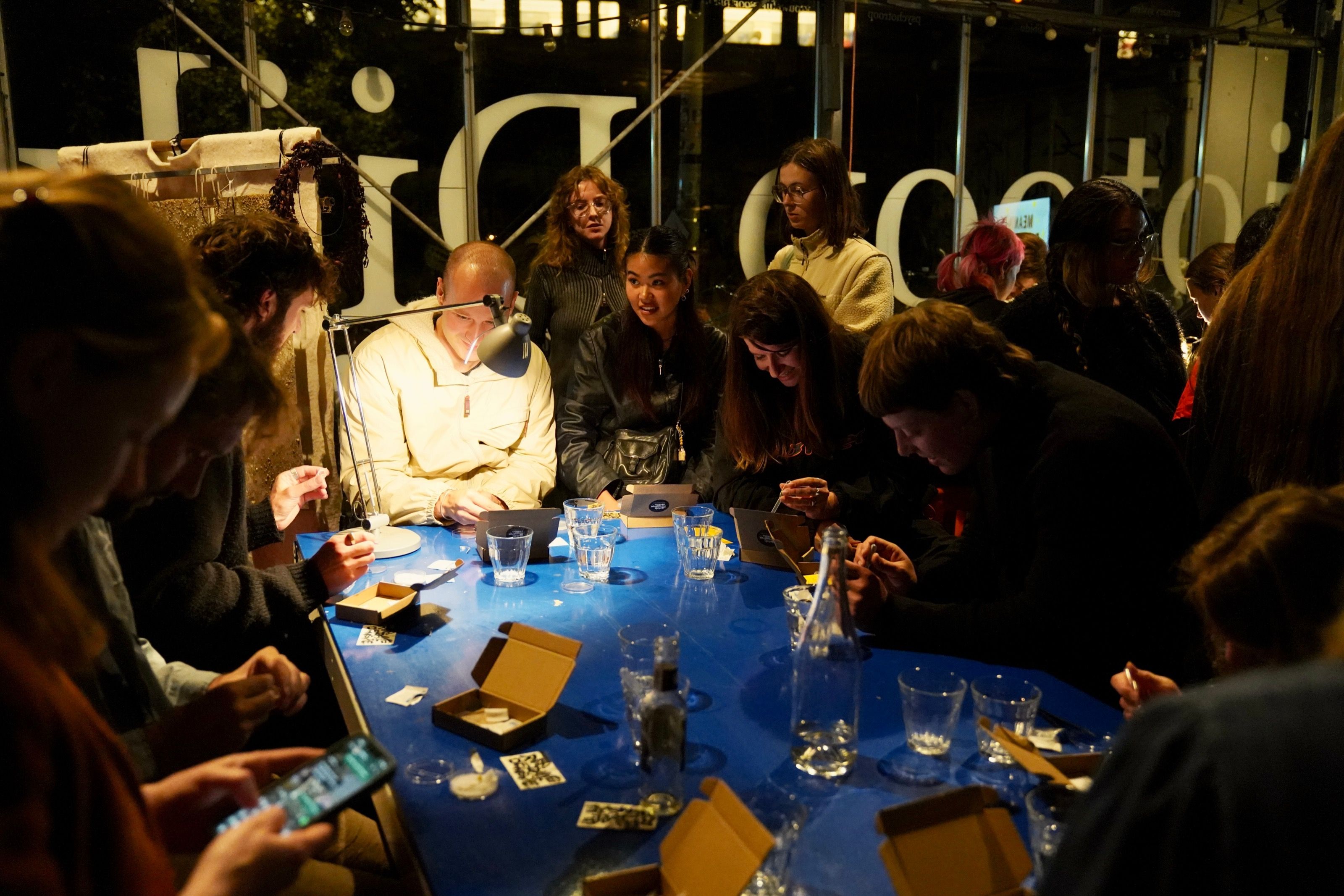 Evening slime mould workshop with participants around a blue table