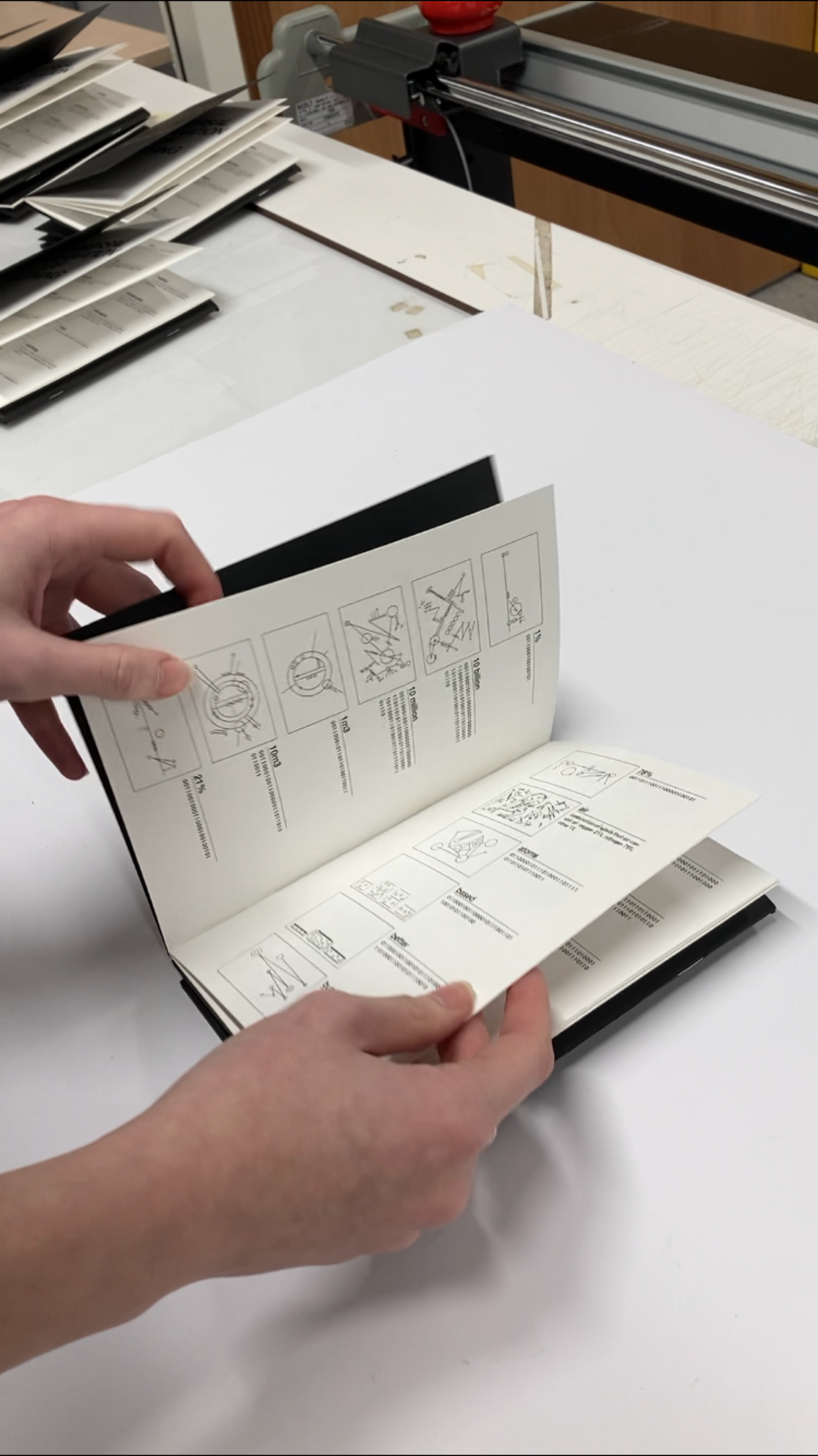 Hands flipping through the pages of Universal Explanation of Nothing