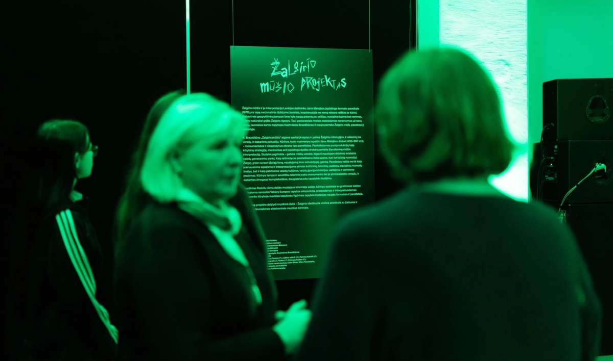 Visitors reading wall text at the Žalgiris Battle Project exhibition