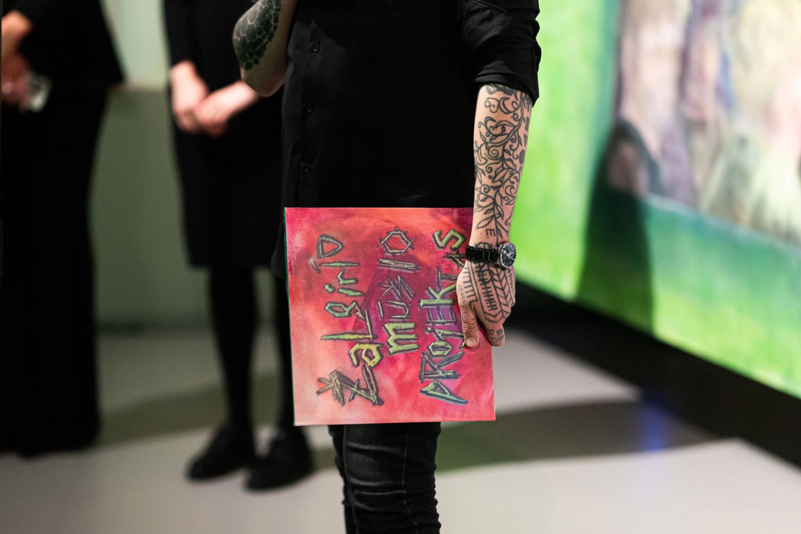 Person holding the Žalgiris Battle Project vinyl sleeve at an exhibition