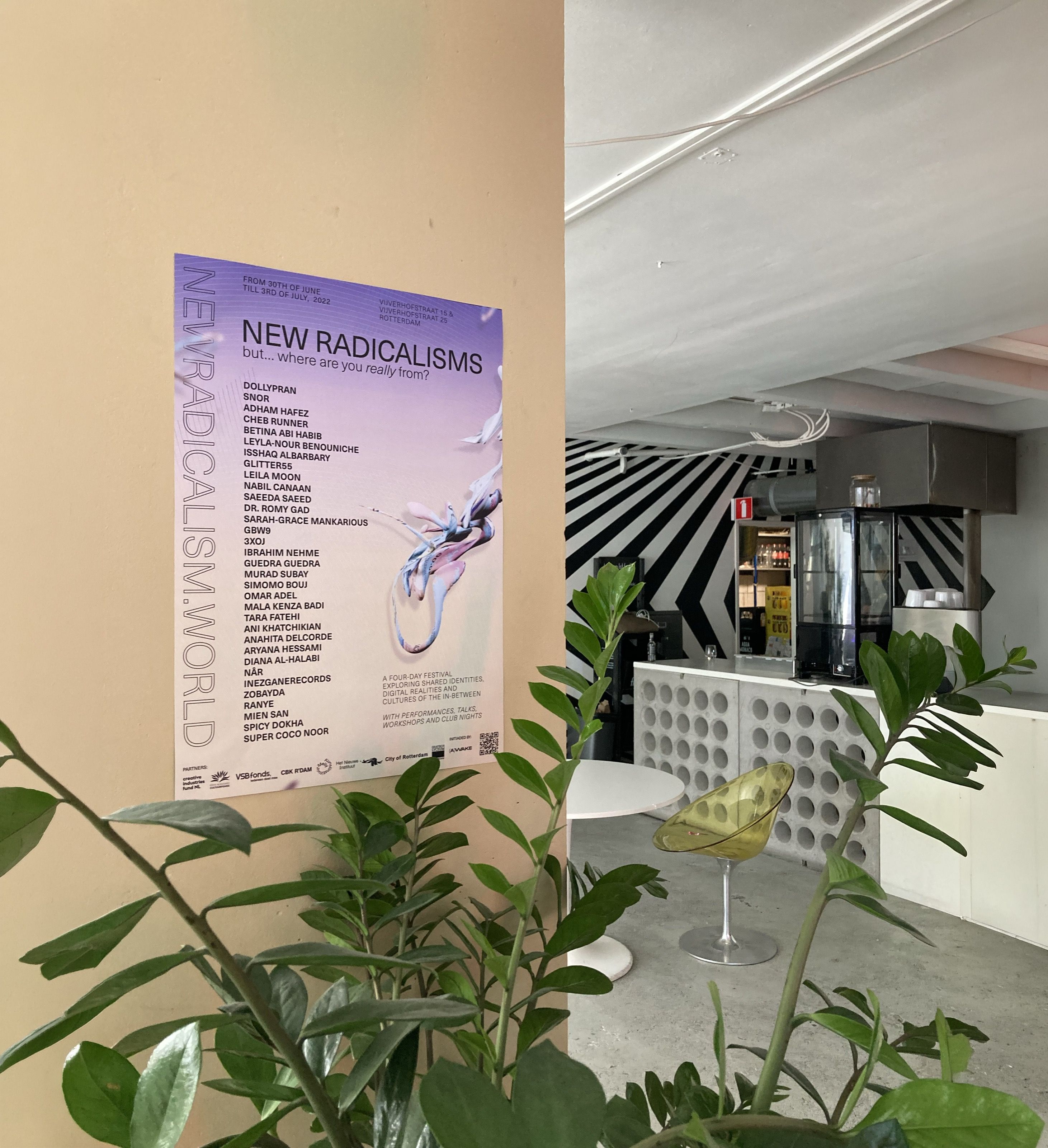 New Radicalisms lineup poster on a pillar beside a plant