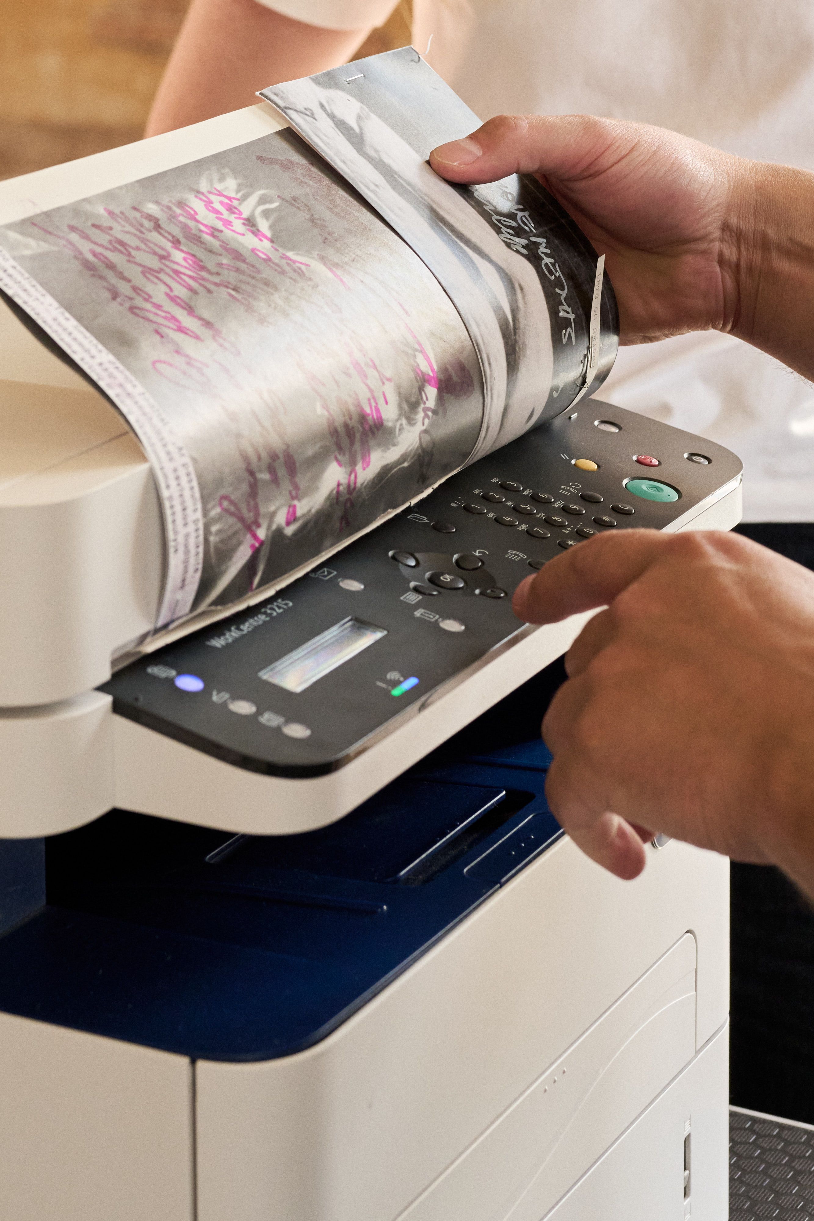 Zine pages coming out of a photocopier