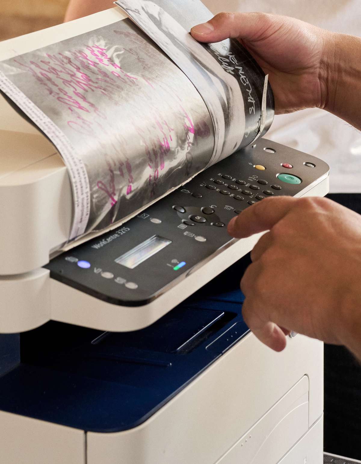Zine pages coming out of a photocopier
