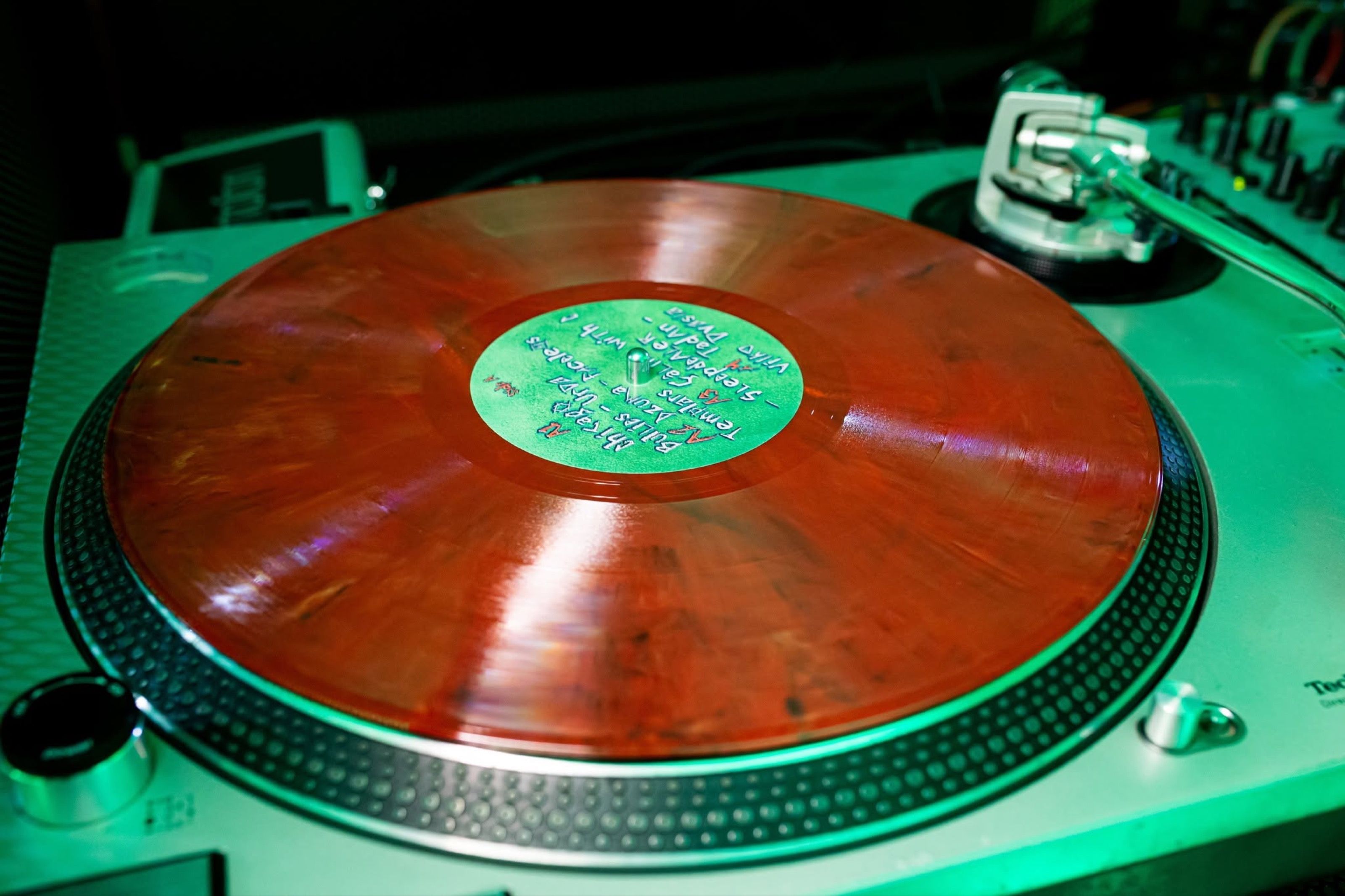 Red marbled Žalgiris Battle Project record on a turntable