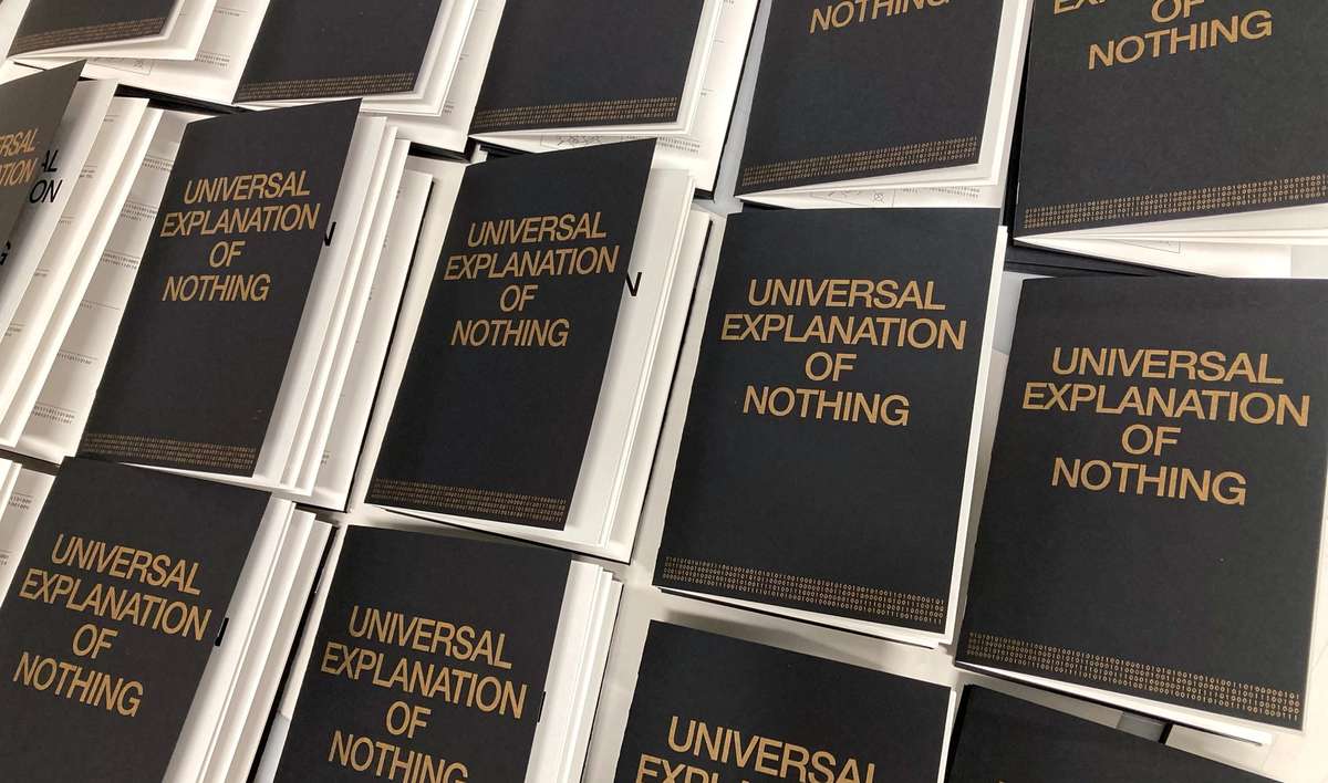Stacks of Universal Explanation of Nothing books with gold lettering