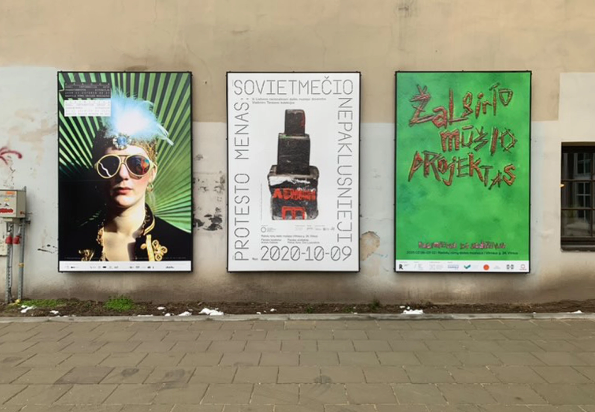 Exhibition posters including Žalgiris Battle Project pasted on a street wall